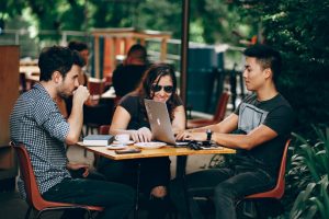 Group of people working in coffee shop